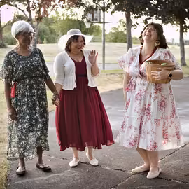 Antonia and her niece Hero share a moment of laughter with their cheeky maidservant Margaret in the play Much Ado About Nothing.