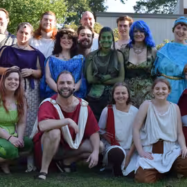 The full cast for the play A Midsummer Night's Dream poses in costume before a show.
