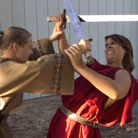 Two soldiers angrily clash swords in the civil war following Caesar’s death in the play Julius Caesar.